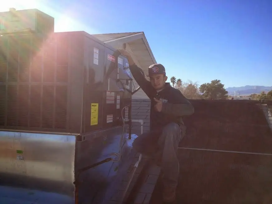 HVAC technician performing HVAC Inspection on a rooftop unit in Shady Hollow